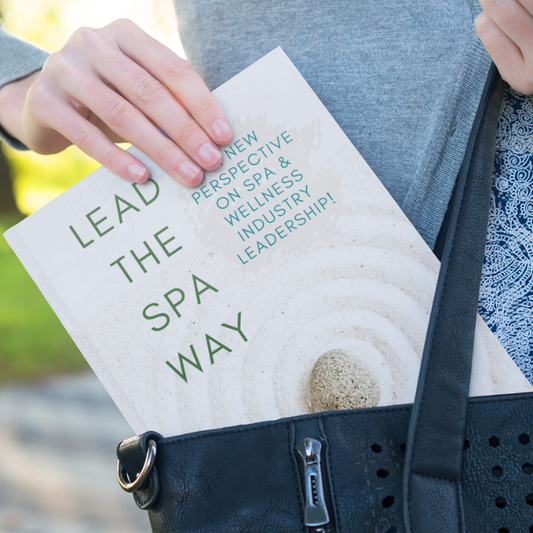 Solo Spa Pros Lead The Spa Way Book in woman's purse Mockup 01